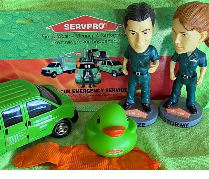 Stormy and Blaze by a SERVPRO van with advertisement